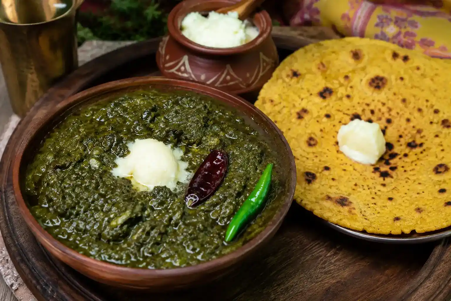 Sarson ka saag with makki di roti and a spoon of white butter, a traditional Punjabi dish