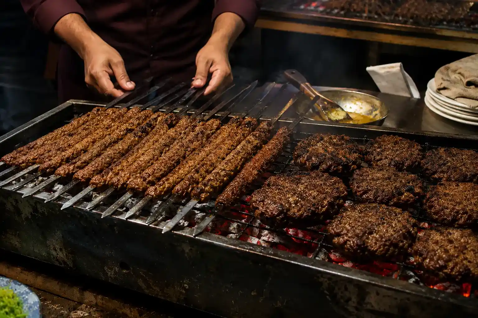 Seekh kabab and chapli kabab grilling on a charcoal grill, popular Pakistani street